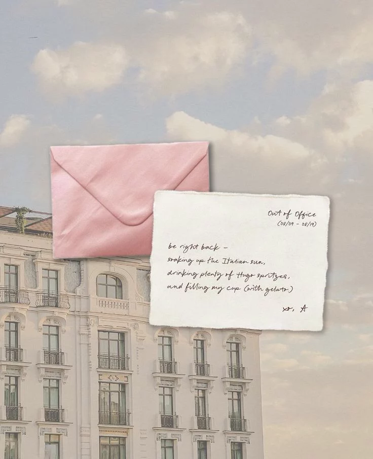 A pink envelope and handwritten note against a soft sky